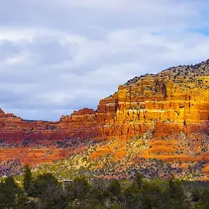 Deep red banded Southwest mesas brilliantly lit by the sun.