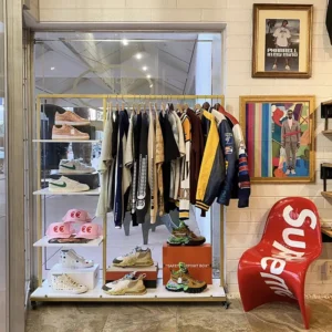 Display of hanging jackets and tops, shoes, and hats.