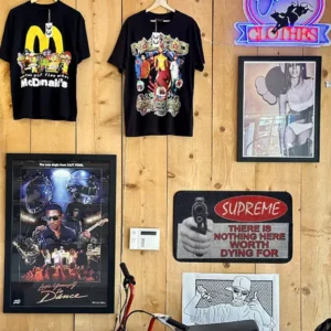Brown panel wood wall of vintage posters and tees.