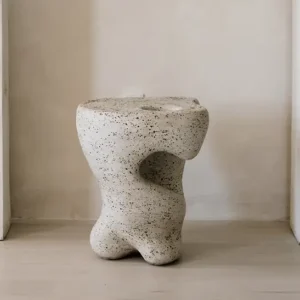 Open, organic and slumped clay sculptural form as a seat or small table.